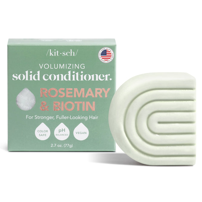 A green box labeled as Kitschs Rosemary & Biotin Solid Conditioner sits next to a matching geometric bar enhanced with NaturePep® Amaranth. The color-safe, pH-balanced, and vegan formula weighs 2.7 oz (77g).