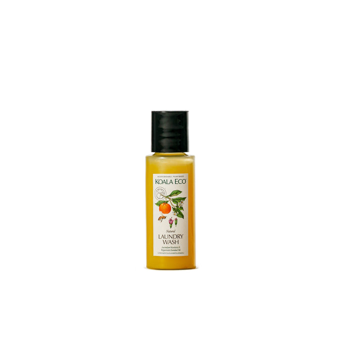 A small bottle of Koala Eco Laundry Wash - Sample with a black cap and a label featuring orange slices, leaves, and flowers. This eco-friendly formula contains natural essential oils and non-toxic ingredients.