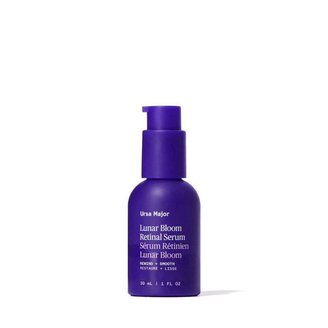 An upright purple bottle of Ursa Major Lunar Bloom Retinal Serum with a pump dispenser is shown against a white background, featuring white text on the label highlighting benefits for fine lines and skin texture.