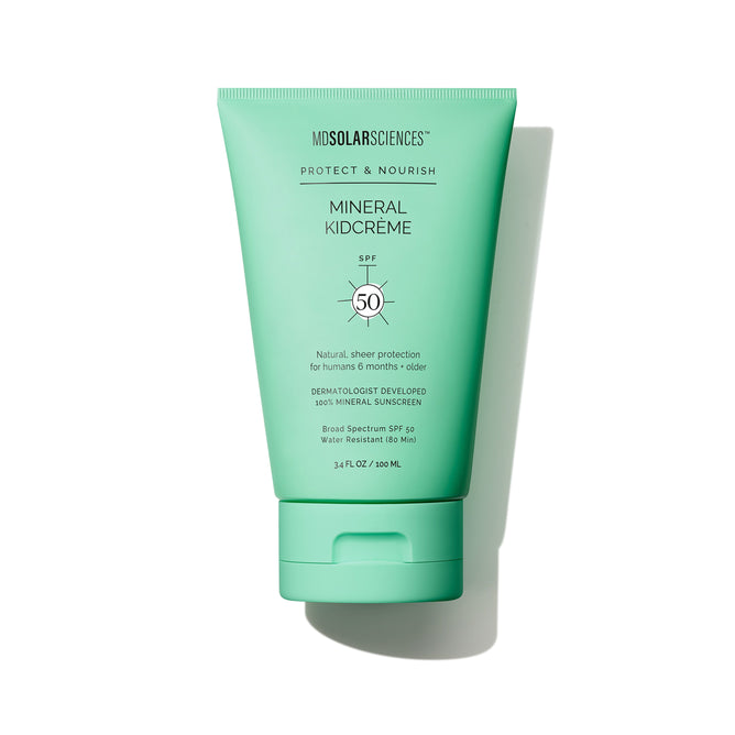 A gentle, green tube of MDSolarSciences KidCreme SPF 50 sunscreen for kids, labeled Protect & Nourish, stands upright on a white background.