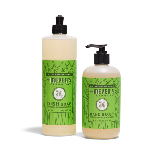 Mrs. Meyer’s Sunsational Sink Essentials - Frush Cut Grass includes Dish Soap (16 fl oz, flip cap) and Hand Soap (12.5 fl oz, pump), both with green grass-themed labels.