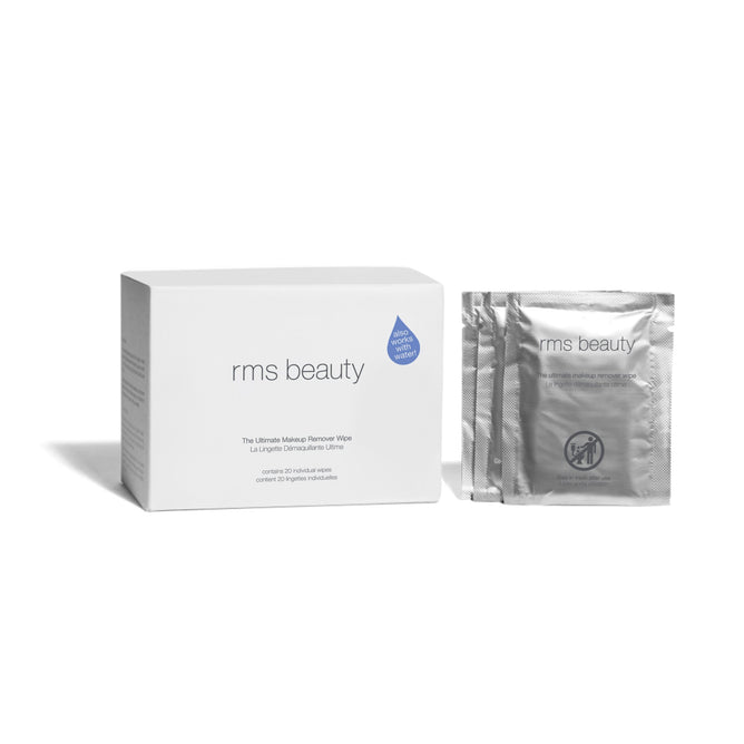 A white RMS Beauty Ultimate Makeup Remover Wipes box sits beside two individual silver packets, all displayed on a plain white background.