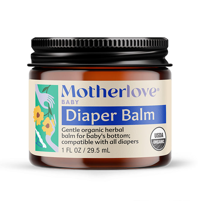 A 1 fl oz (29.5 mL) jar of Motherlove Diaper Balm with a black lid and blue floral label, USDA Organic certified. This gentle herbal balm is safe for babys bottom and cloth diapers.