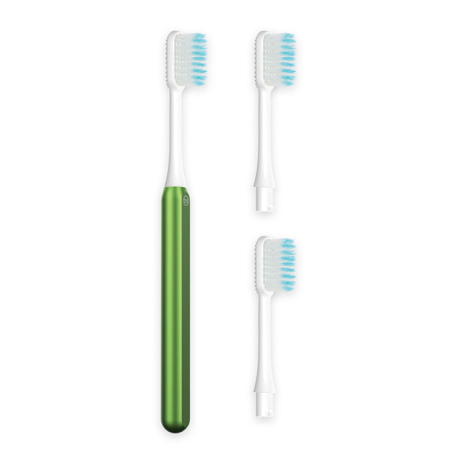 The Nada Soft Kids Toothbrush, shown in green and white with blue bristles alongside two replacement heads on a white background, offers an easy way to reduce waste and recycle less often.