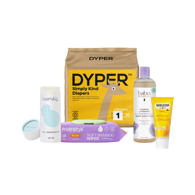 The Grove Collaborative Ultimate New Baby Gift Set includes DYPER diapers, Babo Botanicals wash, Weleda cream, Freestyle bamboo wipes, an Esembly deodorant stick, and a small blue container.