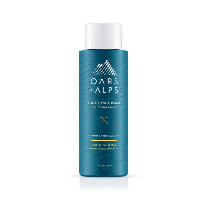 A teal bottle of Oars + Alps Cali Coast Body Wash with white text and a mountain logo. The label notes Vitamin E, antioxidants, and that it’s free of parabens, phthalates, and sulfates.