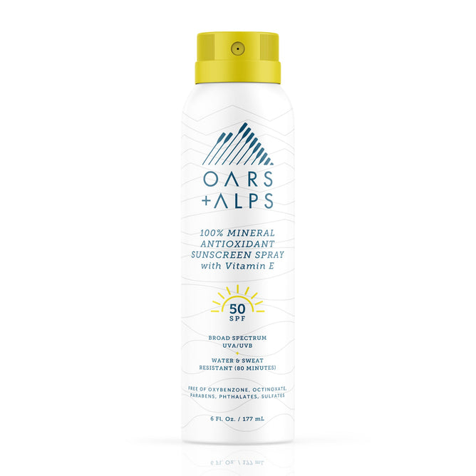 A can of Oars + Alps 100% Mineral Antioxidant Sunscreen Spray - SPF 50 comes in a white can with blue text and a yellow cap, offering broad spectrum protection and water resistance for 80 minutes.