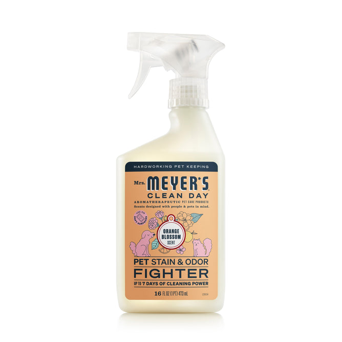 Mrs. Meyers Pet Stain & Odor Fighter in an off-white bottle with a clear spray nozzle offers 17 days of cleaning power from plant-derived ingredients and probiotics for lasting freshness, featuring an orange blossom scent.