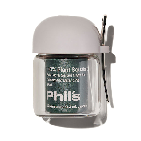 A small clear jar labeled Phils 100% Plant Squalane Serum Capsules - First Phil, with a white cap and clip, holds 20 single-use 0.3 mL capsules for deep hydration.