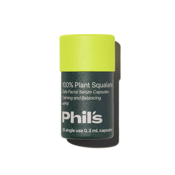 A green cylindrical container with a light green cap labeled Phils 100% Plant Squalane Serum Capsules - RePhil, featuring upcycled plant squalane for hydration support; includes 20 single-use 0.3 mL capsules on a white background.