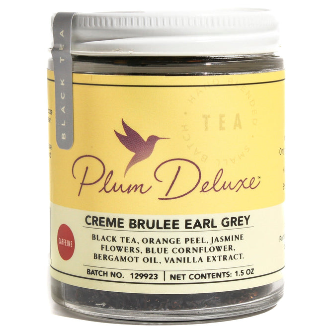 A 1.5 oz jar of Plum Deluxe Creme Brulee Earl Grey with Jasmine & Vanilla Tea, in a yellow label with purple hummingbird, blends bergamot, creamy vanilla, and jasmine for a unique Cream Earl Grey experience.