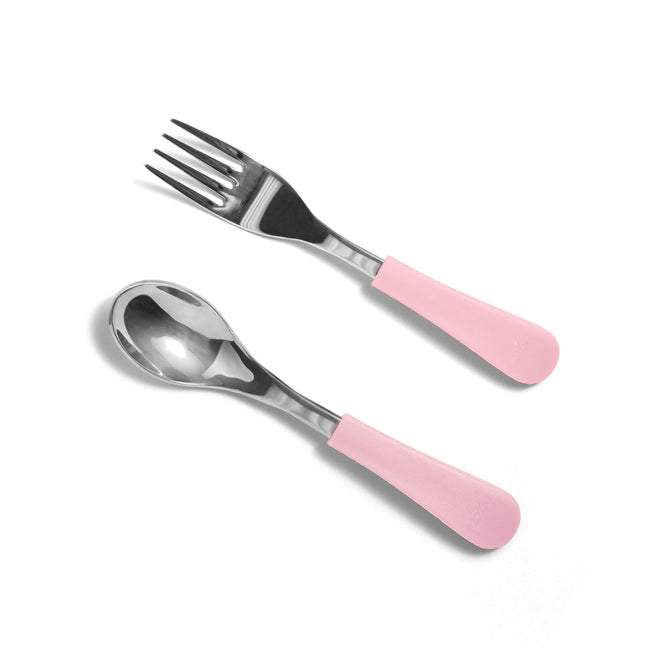 The Avanchy Stainless Steel, Non-Toxic Baby and Toddler Fork and Spoon Set, featuring shiny stainless steel heads and pink BPA-free silicone handles, lies elegantly parallel on a white background. Perfect for Baby Led Weaning, this set promises safe and stylish mealtime adventures.