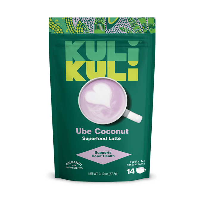 A green Kuli Kuli Foods Organic Superfood Latte package features heart-shaped latte art in a purple drink, highlighting organic, antioxidant-rich ingredients, heart health and metabolism support, and 14 servings.