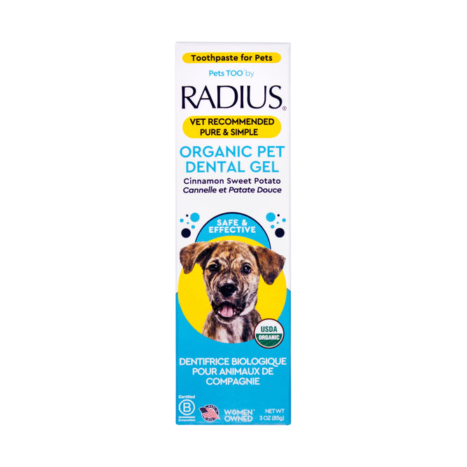 A box of Radius USDA Organic Canine Toothpaste with a dog image, cinnamon sweet potato flavor, English and French text, vet recommended, and USDA Organic certified.