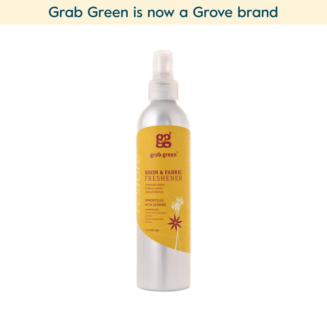 A silver spray bottle of grab green Room and Fabric Freshener - Immortelle with Jasmine (Coming Soon!) with a yellow label featuring jasmine flowers. Made with essential oils, it’s now a Grove brand. Text above: grab green is now a Grove brand.