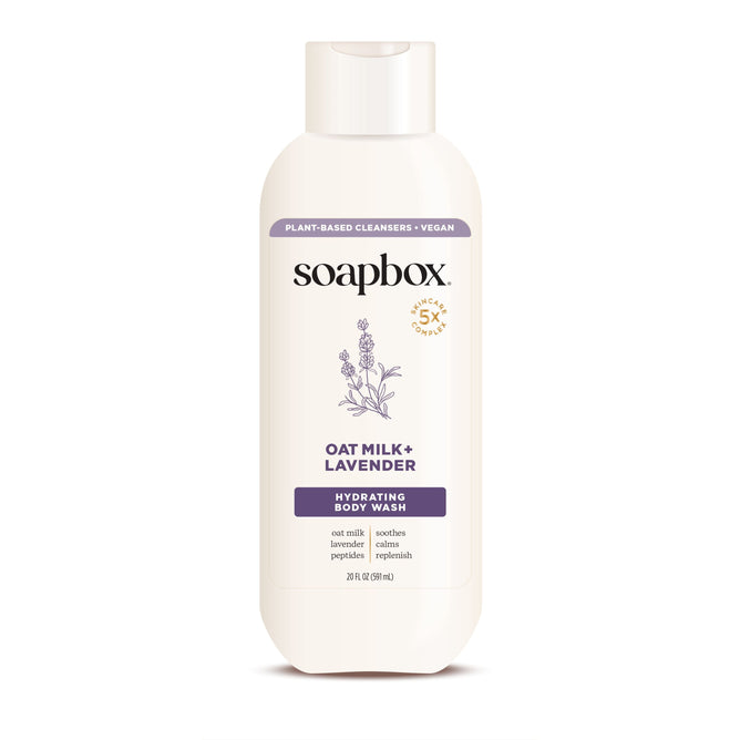 A 20 fl oz bottle of Soapbox Oat Milk + Lavender Nourishing Body Wash offers calming hydration with plant-based cleansers and vegan ingredients, featuring lavender imagery to highlight its soothing properties.