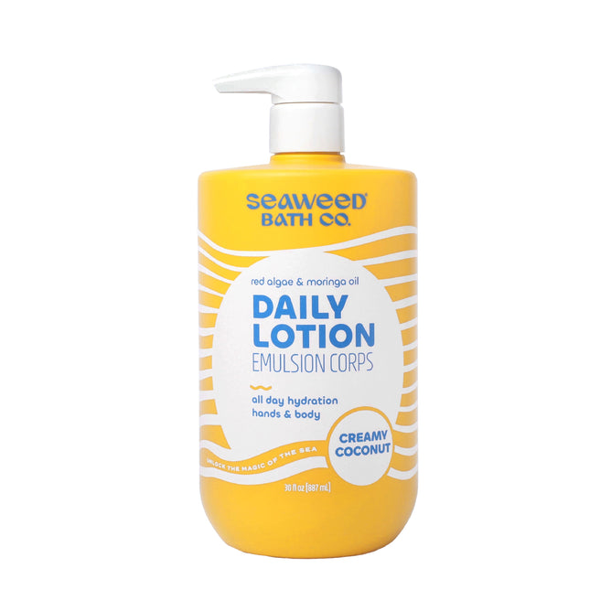 A 12 fl oz yellow pump bottle of The Seaweed Bath Co Value Size Daily Lotion in Creamy Coconut, enriched with nutrient-rich algae, shea butter, and moringa oil for all-day hydration. Perfect for hands and body.
