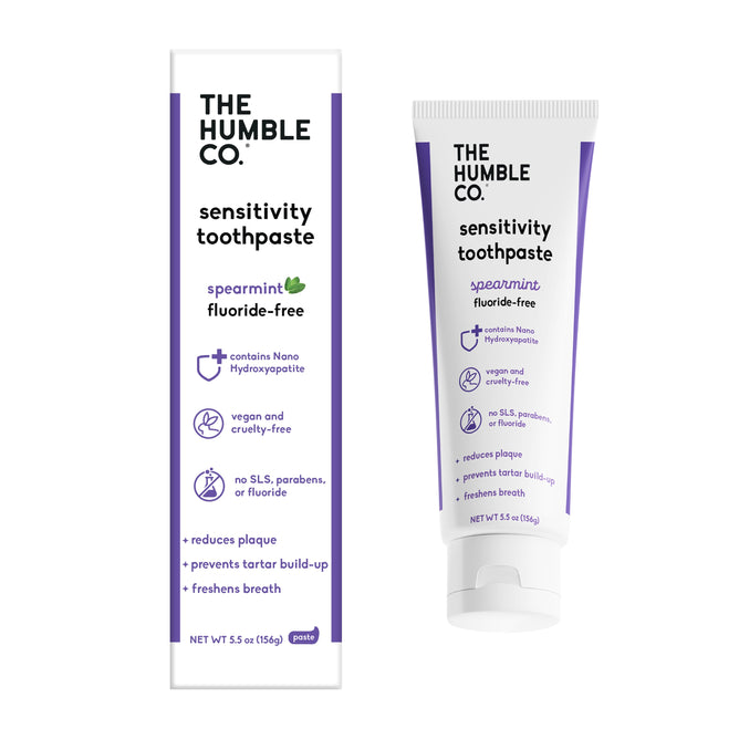A tube and box of The Humble Co. Sensitivity Toothpaste in spearmint. This vegan, cruelty-free, fluoride-free formula with nano-hydroxyapatite helps reduce plaque and tartar—ideal for sensitive teeth. SLS-free packaging highlighted.