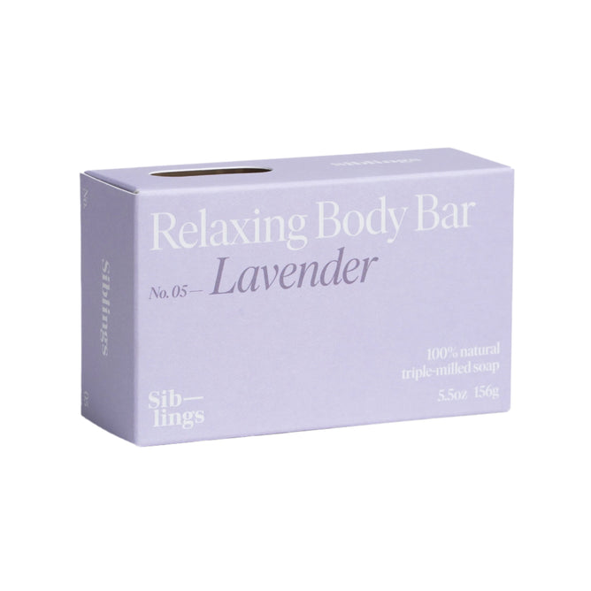 A lavender-colored box is labeled Relaxing Body Bar, No. 05 - Lavender with essential oils to nourish your skin. It contains 100% natural triple-milled soap, weighs 5.5 oz (156 g), and features the brand name Siblings on the sides.