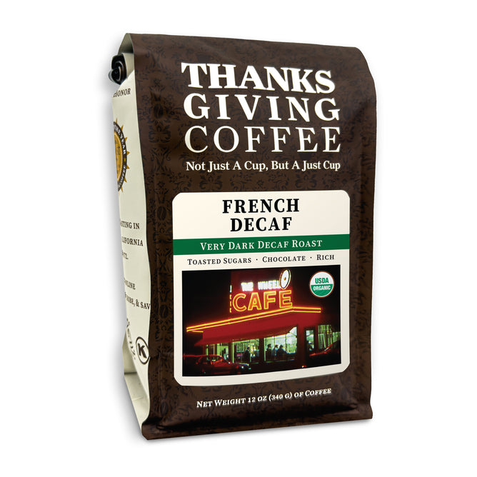 A 12 oz brown bag of Thanksgiving Coffees Organic French Decaf showcases a lit-up cafe. Enjoy very dark, USDA Organic-certified beans with toasted sugar and rich chocolate notes. Savor the purity of mountain water decaffeination in every sip.