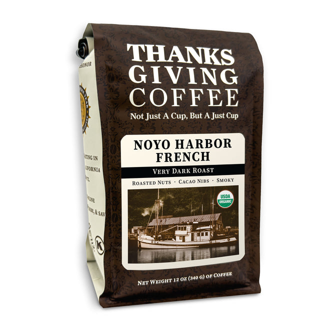 Thanksgiving Coffees Organic Noyo Harbor French bag offers sustainable, USDA Organic, Very Dark Roast coffee with roasted nuts, cacao nibs, and smoky notes. A sepia boat image highlights its artisanal craftsmanship.