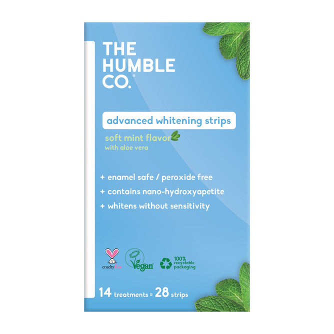 A box of The Humble Co. Advanced Whitening Strips, peroxide-free and enamel-safe in soft mint flavor, with 28 strips (14 treatments) in recyclable packaging. Mint leaves accent the corners.