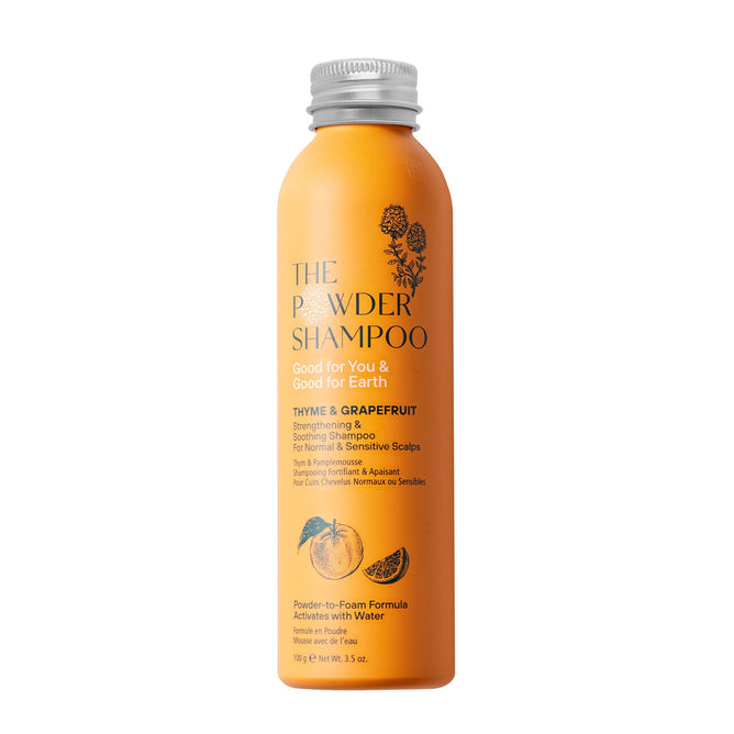 The Strengthening & Soothing Powder Shampoo by The Powder Shampoo comes in an orange bottle. Featuring thyme and grapefruit oil for normal/sensitive scalps, it showcases eco-friendly botanical designs and an innovative powder-to-foam formula.