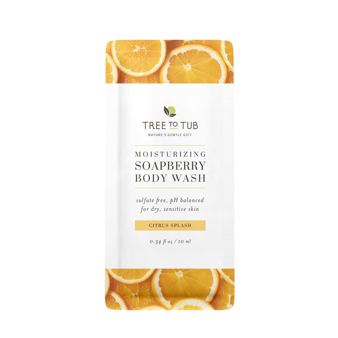 A sachet sample of Tree To Tub Moisturizing Vitamin C Body Wash for Sensitive Skin features sliced orange designs on the packaging and product details in black text on a white label.