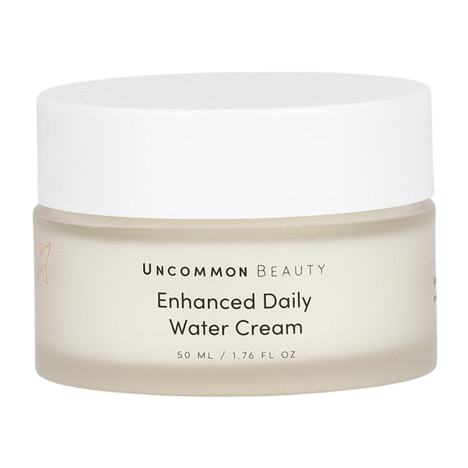 Uncommon Beauty Enhanced Daily Water Cream comes in a 50 ml frosted jar with a white lid. This lightweight moisturizer hydrates and supports your skin barrier for a radiant complexion.