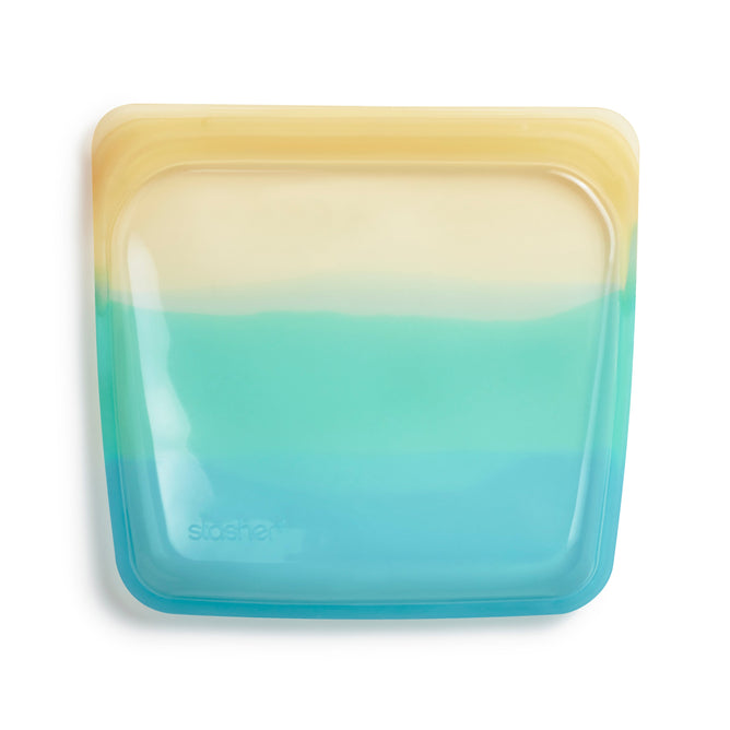 The Sandwich Bag from Stashers Endangered Seas Collection is a square reusable bag made of food-grade silicone. It features a beautiful gradient design, transitioning from yellow to light blue with a transparent center and rounded edges, ideal for eco-conscious ocean conservation supporters.