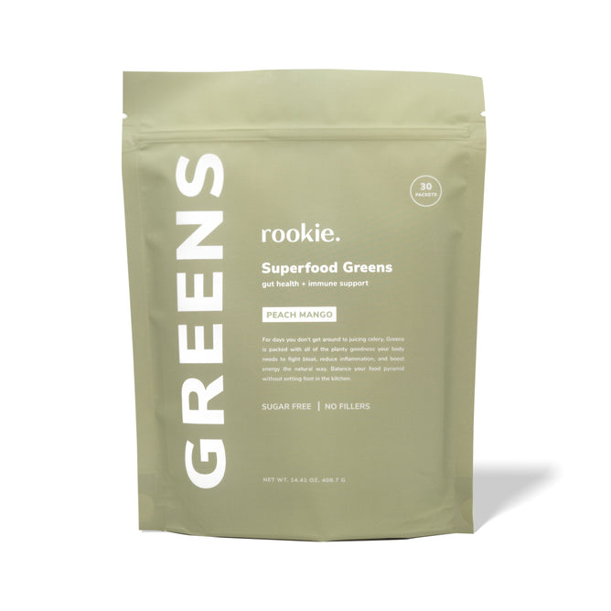 The light green Rookie Wellness Greens + Superfood package in PEACH MANGO flavor enhances gut health and immunity with antioxidants. Its sugar-free, filler-free, and offers 30 servings for a healthier you.