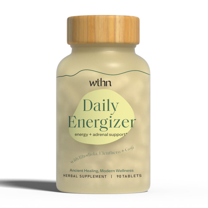 The WTHN Daily Energizer herbal supplement features a beige label and wooden cap. This blend, including Rhodiola, Eleuthero, and Goji, boosts energy for workouts and combats adrenal fatigue. It offers ancient healing with modern wellness in 90 tablets.