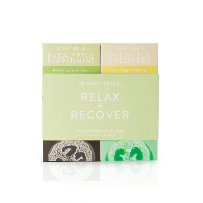 The Honey Belle Exfoliating Loofah Soap Gift Set, infused with coconut oil, includes Eucalyptus Peppermint and Green Tea Cucumber soaps. Presented in pastel green and beige packaging, its ideal for a home spa day against a white backdrop.