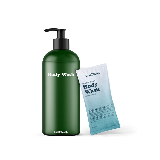 A LastObject Body Wash Starter Set in a green bottle is beside a blue packet of Powder-based Body Wash, both utilizing natural sugars in their innovative skincare.