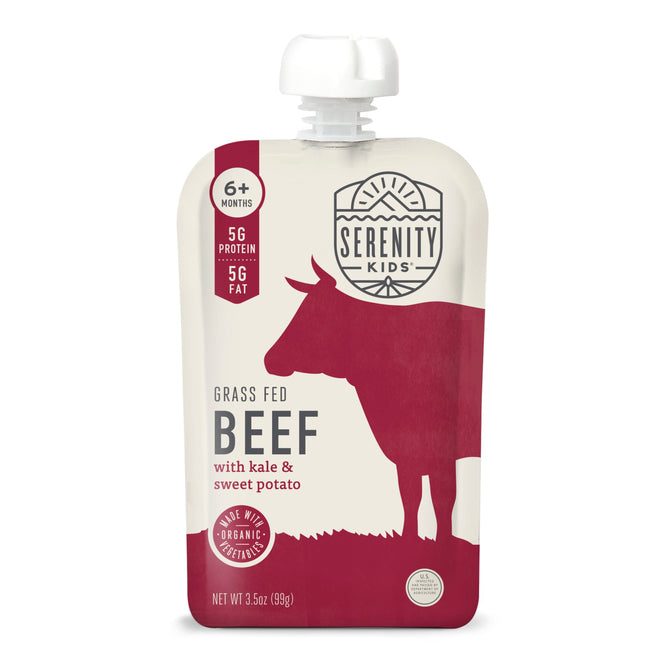 A pouch of Serenity Kids Grass-Fed Beef with Organic Kale & Sweet Potato baby food, suitable for ages 6 months and up, features Omega-3s. The white and red packaging includes a cow silhouette and nutritional details.