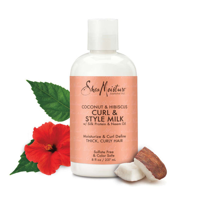SheaMoistures Coconut + Hibiscus Curl & Style Milk features a vibrant red hibiscus, lush green leaves, and fresh coconut on the label. Its sulfate-free and color-safe, ideal for nurturing thick, curly hair.
