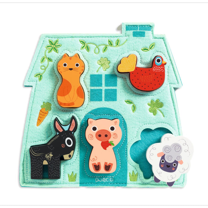The DJECO Perfect First Puzzle is a farm-themed, house-shaped puzzle for kids. Made from FSC® Certified Wood, it includes colorful animal pieces: cat, bird, donkey, pig, and sheep. The teal background features a window and carrot design with slots that match each animal piece for playful learning.