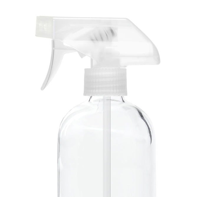 Against a white backdrop, a clear Grove Co. Replacement Spray Nozzle glass bottle features a white trigger nozzle posed sideways, revealing the straw inside and showcasing its functional twist & slide reusable cleaning design.