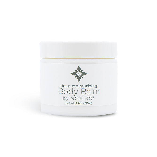 Nonikos Body Balm comes in a minimalist white jar with a star-like logo, offering 2.7 oz (80 ml) of deep moisturizing and hydrating product.