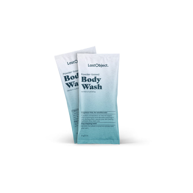 Two sachets of LastObjects Bodywash Refill stand upright, featuring white-to-teal gradient packaging. The text emphasizes its gentle, hydrating formula for sensitive skin infused with natural sugars.