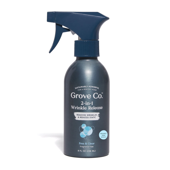 A dark blue 2-in-1 Wrinkle Release bottle from Grove Collaborative stands against a white backdrop, highlighting its wrinkle release magic and static cling reduction. Its fragrance-free and crafted from 100% recycled plastic, reflecting eco-friendly practices.