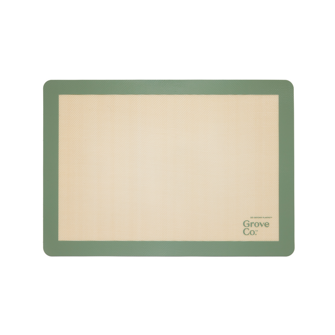 The Silicone Baking Mat from Grove Co. is rectangular and eco-friendly, with a beige center and green border. Grove Co. is elegantly printed on the bottom right, blending style and functionality into your baking routine.