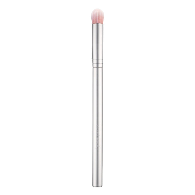 A stylish silver Eyeshadow Brush from RMS Beauty showcases a long handle and soft, round, light pink bristles, ideal for applying or blending cosmetics, against a white background.