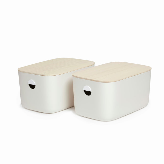 The Large Storage Bins by Open Spaces feature a sleek, minimalist design with two off-white boxes with rounded corners and light wooden lids. Each bin includes a circular side hole for easy handling or ventilation, enhancing functionality and aesthetics with their durable, stackable design.