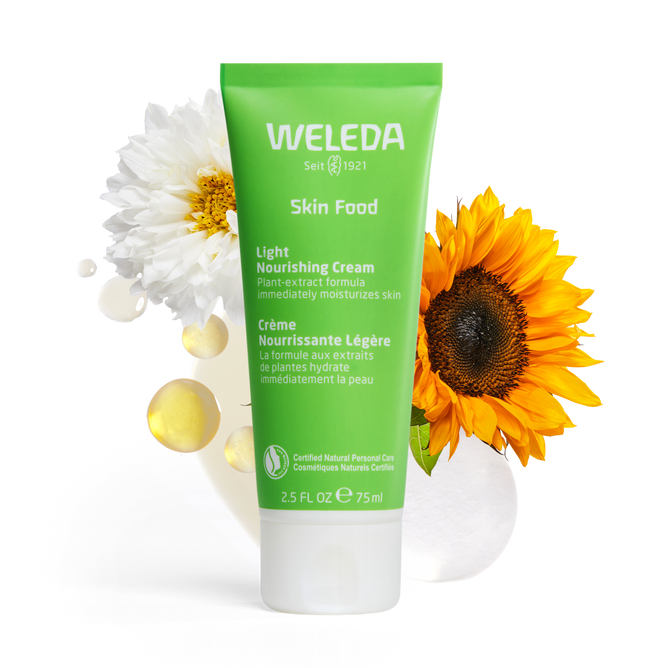 A 2.5 fl oz (75 ml) green tube of Weleda Skin Food Light Nourishing Cream, featuring English and French text, is surrounded by a white flower and a sunflower. The transparent background accentuates the moisturizers natural essence.