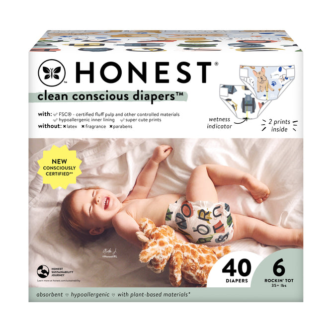 The Honest Companys Clean Conscious™ Disposable Diapers Box features a smiling baby with a patterned diaper cuddling a plush giraffe against a white background. It boasts advanced absorption, blowout protection, hypoallergenic, plant-based materials and contains 40 diapers for babies over 35 lbs.