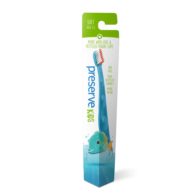 The Preserve Kids Soft Toothbrush, ideal for ages 1-6, features a playful fish design with soft, blue bristles in eco-friendly green and white packaging. Made from recycled yogurt cups and BPA-free.