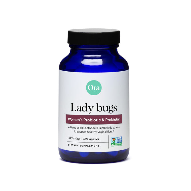 Ora Organics Lady Bugs Womens Probiotic Capsules come in a blue bottle with a black lid. This non-GMO dietary supplement, designed to support urinary tract health, offers 30 servings with 60 capsules.