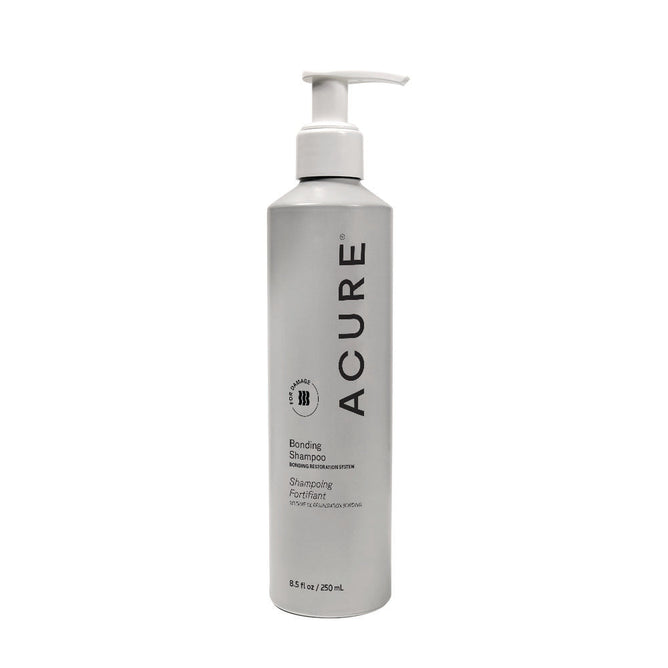 A silver 8.5 fl oz Acure Bonding Shampoo bottle with a white pump, black text, and circular logo. Features the Hair Bonding Restoration System to improve strength and reduce breakage.