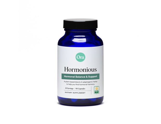 The Ora Organic Hormonious capsules provide hormonal support, featuring 90 adaptogen capsules for 30 servings. The blue bottle showcases a green logo and text on a white background.